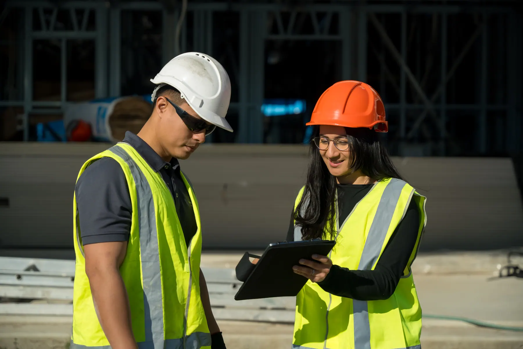 Installers reviewing quality-audit documentation on site